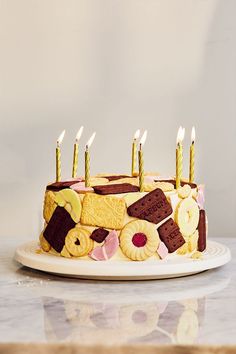 a birthday cake with many lit candles on it