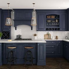 a kitchen with dark blue cabinets and white counter tops, two bar stools in front of the island