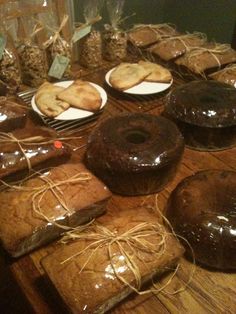 there are many different types of donuts on the table with pineapples around them