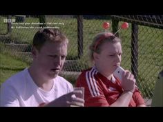 a man and woman sitting next to each other on a tennis court with balls in their hair