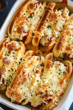 a casserole dish filled with cheesy bread and cheeses on top