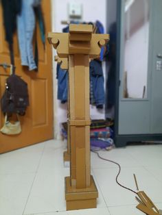 a clock made out of cardboard sitting on the floor