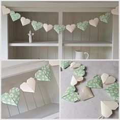 some paper hearts are hanging on the wall and in front of a shelf with other items