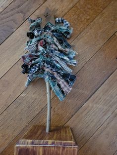 a small tree made out of fabric sitting on top of a wooden floor