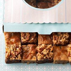 a box filled with brownies covered in caramel