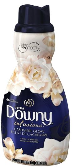 a bottle of downy hand soap with white flowers on the front and blue lid