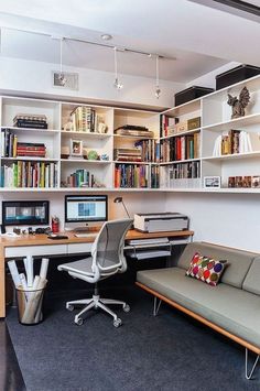 a home office with bookshelves, desk and couch