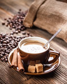 cup of cappuccino with cinnamon on wooden table