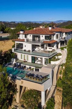 an aerial view of a house with swimming pool in the foreground