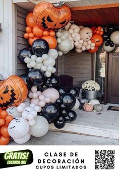 an assortment of halloween balloons in front of a house