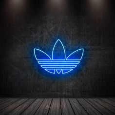 a blue neon adidas logo on a dark wall