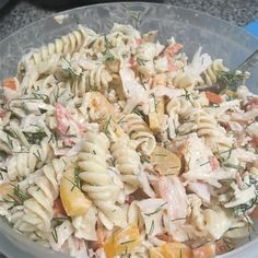 a bowl filled with pasta salad on top of a table