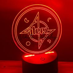 a red neon sign with the word azez on it in front of a dark background