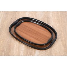 an oval wooden tray with black handles