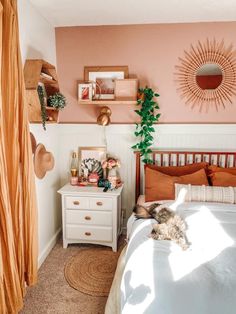 a bed room with a neatly made bed and a dresser