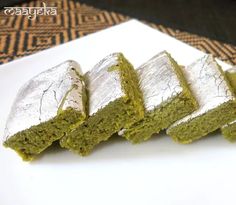 four pieces of cake sitting on top of a white plate