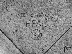 the sidewalk has writing on it that says, netches heal and an inverted pentagram