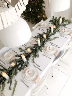 the table is decorated with greenery and candles for christmas dinner party or wedding reception