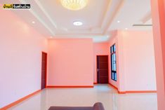 an empty room with pink walls and orange trim