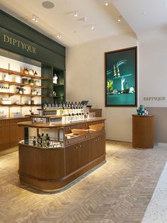 an empty store with many bottles on the counter and shelves full of perfumes in it