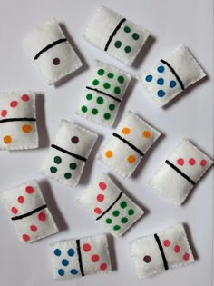 several pieces of felt that have been made to look like dices with colored dots on them