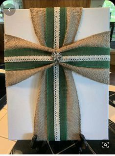 a white box with a green ribbon tied around it