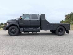 a large black truck parked in a parking lot