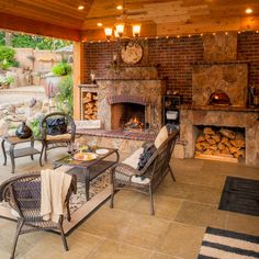 an outdoor living area with fireplace, chairs and tables