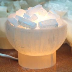 a bowl filled with ice cubes sitting on top of a table