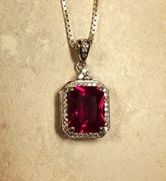 "Stunning Ruby Red Gem Rectangular  Necklace, 8x10mm Emerald Cut Lab Created Simulated Ruby, See Video! 925 Sterling Silver Cubic Zirconia Trimmed Pendant, Rhodium Plated, 18\" Sterling Chain. Gift Box Included." Luxury Ruby Teardrop Pendant Jewelry, Red Gem Pendant, Luxury Ruby Jewelry With Rectangular Stone, Formal Red Rectangular Necklaces, Red Square Pendant Gemstone Jewelry, Red Gemstone Jewelry With Square Pendant, Red Gemstone Square Pendant Jewelry, Elegant Red Rectangular Necklace, Red Gemstone Square Pendant Necklaces