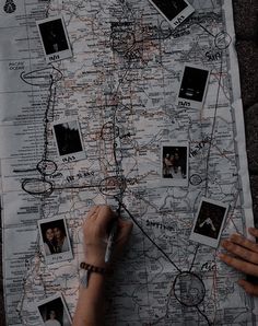 a person is drawing on a map with pictures