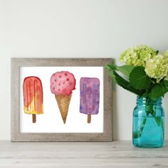 three ice creams are displayed in front of a blue vase with hydrangeas