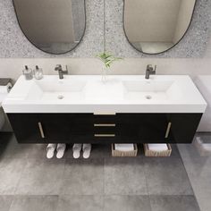 a bathroom with two sinks and mirrors in it