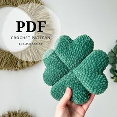 a person holding a four leaf clover in front of a white wall with the text pddf crochet pattern english polsk