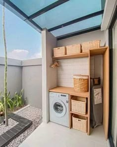 a washer and dryer in a room with a glass roof over it's door