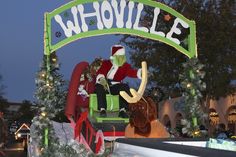 a parade float with santa clause riding on it's back