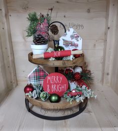 three tiered tray with christmas decorations on it