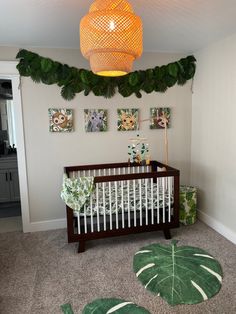 a baby's room with a crib, rugs and pictures on the wall