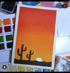 an art project with paint and watercolors on the table