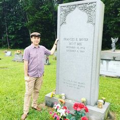 a man standing in front of a grave