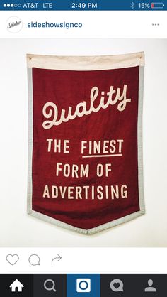 a red banner hanging from the side of a wall that says quality, the finest form of advertising