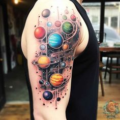 a man with a tattoo on his arm that has planets and stars all over it