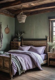 a bed sitting in a bedroom next to a window with a basket hanging from the ceiling