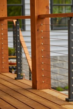 a close up of a wooden deck with metal railings