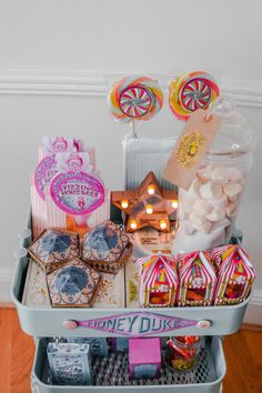 a cart filled with candy and candies on top of a wooden floor