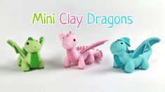 three small toy dragon figurines sitting next to each other on a white background