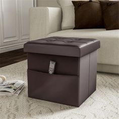 a living room with a white couch and a brown storage box on the floor in front of it