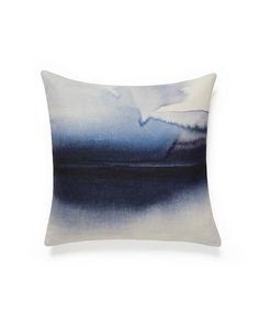 a blue and white pillow on a white background