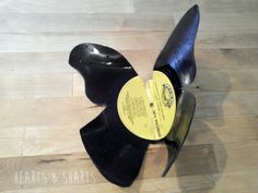 a black propeller on top of a wooden floor