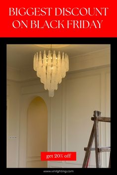 a chandelier hanging from the ceiling in front of a white wall with text reading biggest discount on black friday get 20 % off